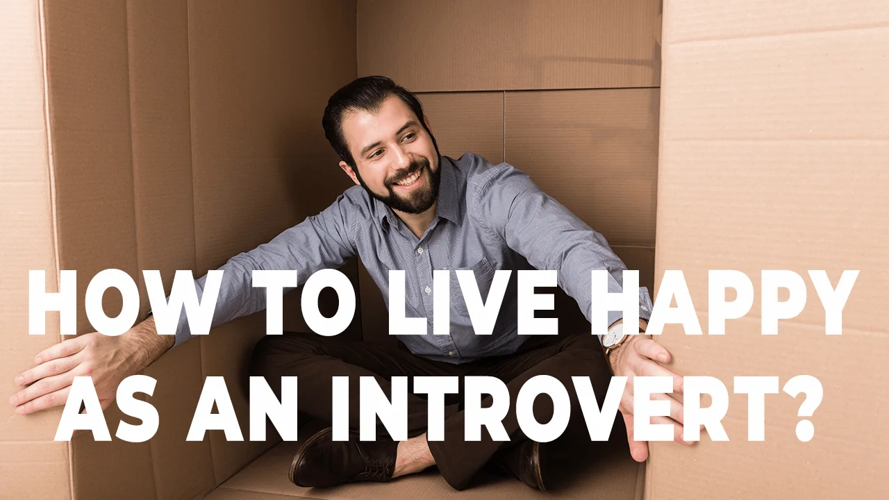 An introvert happy man nestled between cardboard walls, radiating contentment and solitude. The bold text, "HOW TO LIVE HAPPY AS AN INTROVERT?" captures the essence of finding joy in introversion. The man's serene expression and posture in this cozy nook symbolize the inner peace and happiness that introverts can cultivate in their unique way.